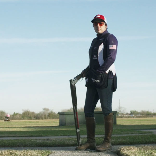 Woman clay shooter posing with unloaded shotgun